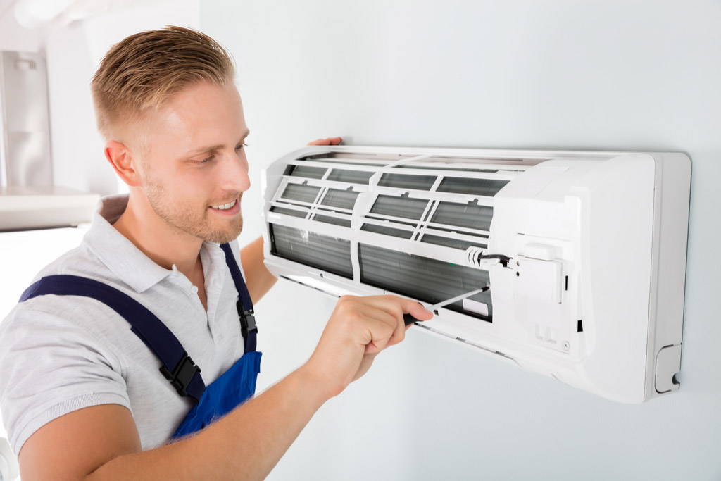 HVAC technician maintaining a ductless air conditioner in Davis