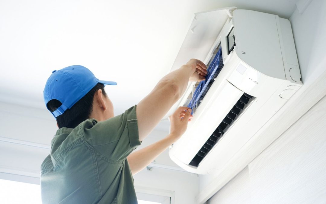 HVAC technician servicing a ductless mini split in Davis