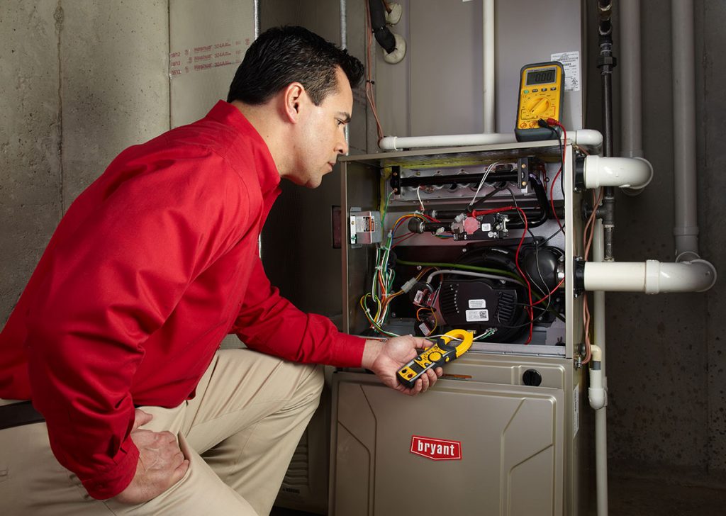Heating technician diagnosing a furnace repair in Davis