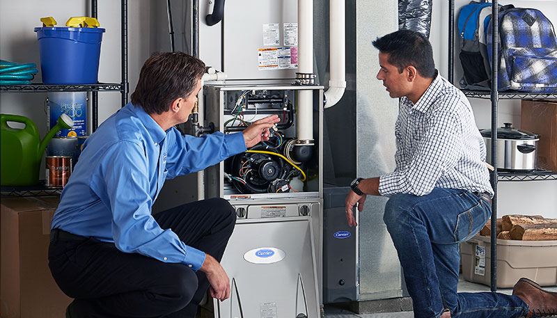Technician evaluating a furnace for repair or replacement in Davis