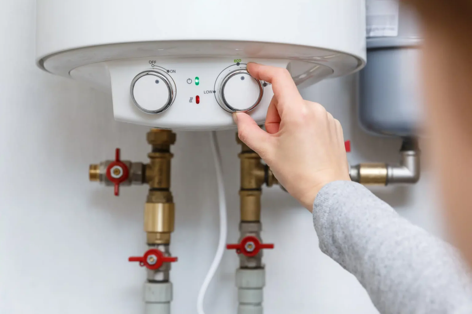 Technician adjusting a water heater in Davis